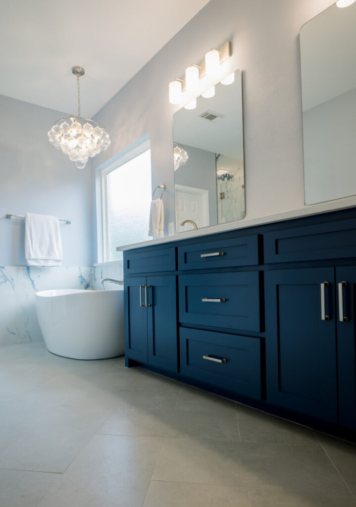 Navy shaker double vanity with freestanding soaking tub, bathroom remodeling by Heritage Remodelers serving Grapevine, TX