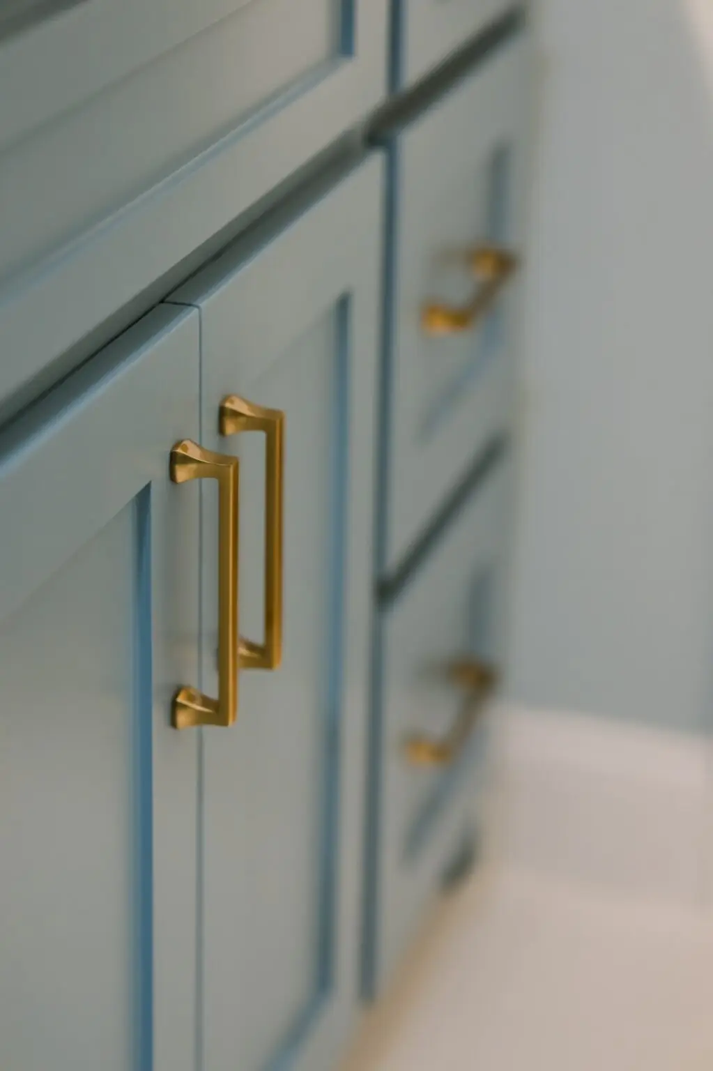 Slate blue shaker bathroom vanity with brushed brass cabinet pulls, bathroom remodel in DFW