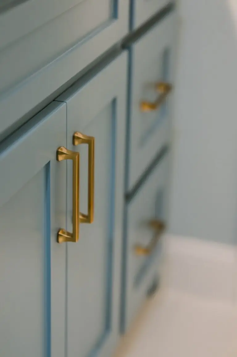 Slate blue shaker vanity with brushed brass cabinet pulls, bathroom remodeling by Heritage Remodelers & Builders in DFW