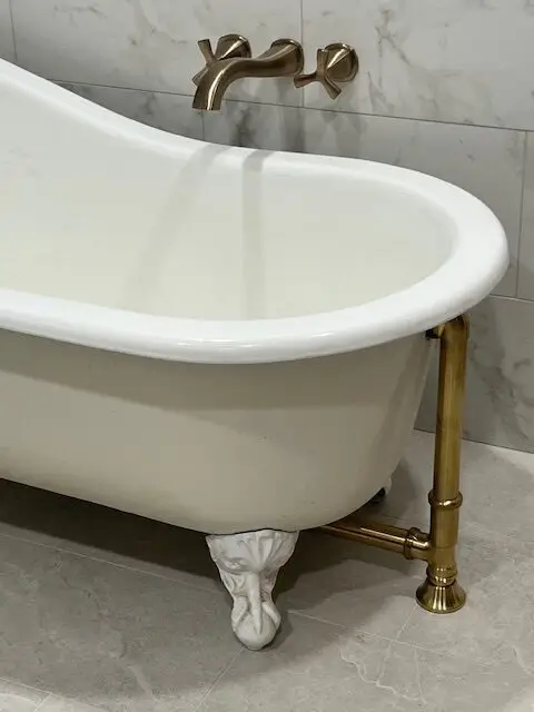 Clawfoot tub with brass wall-mounted faucet, bathroom remodel in DFW